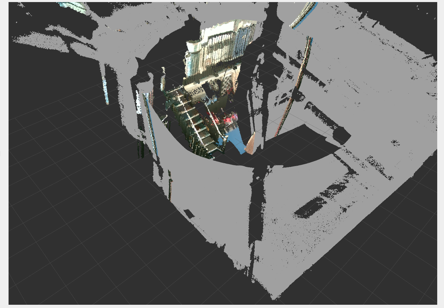 The camera-coloured LiDAR point cloud from the robot's viewpoint: grey floor and geometry, colour where the camera sees